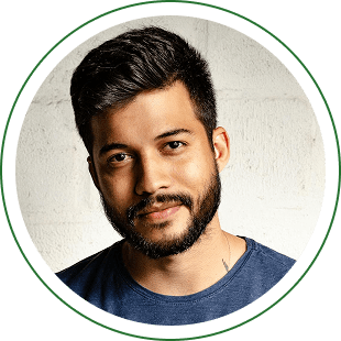 Man with beard and blue shirt smiling.